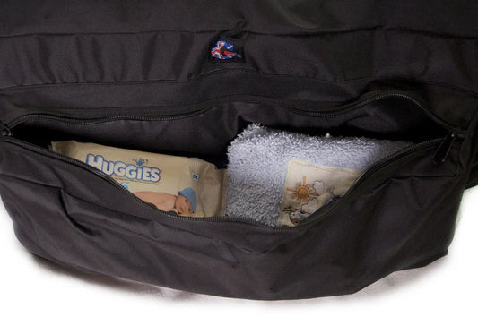 Genesis Travel Bag showing external side pocket packed with wipes and a baby towel